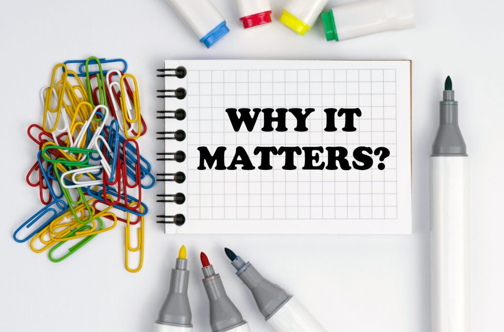 Notebook with the words “Why it matters?” surrounded by paper clips and markers.